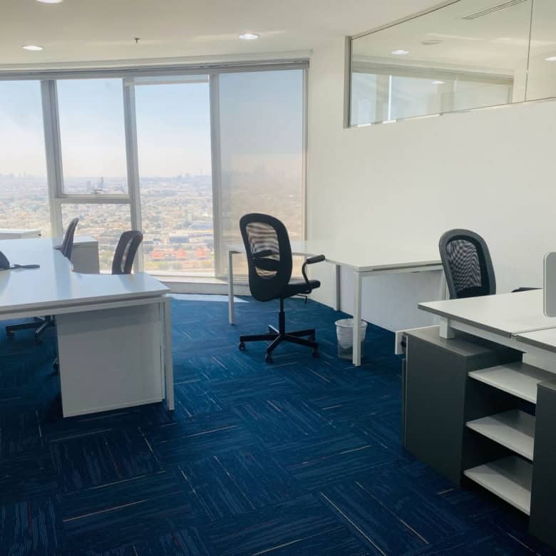 Bright office with large windows and minimal decor in Dubai CBD.