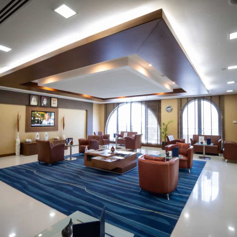 Spacious coworking area featuring leather chairs and large arched windows at Nextspace UAE.