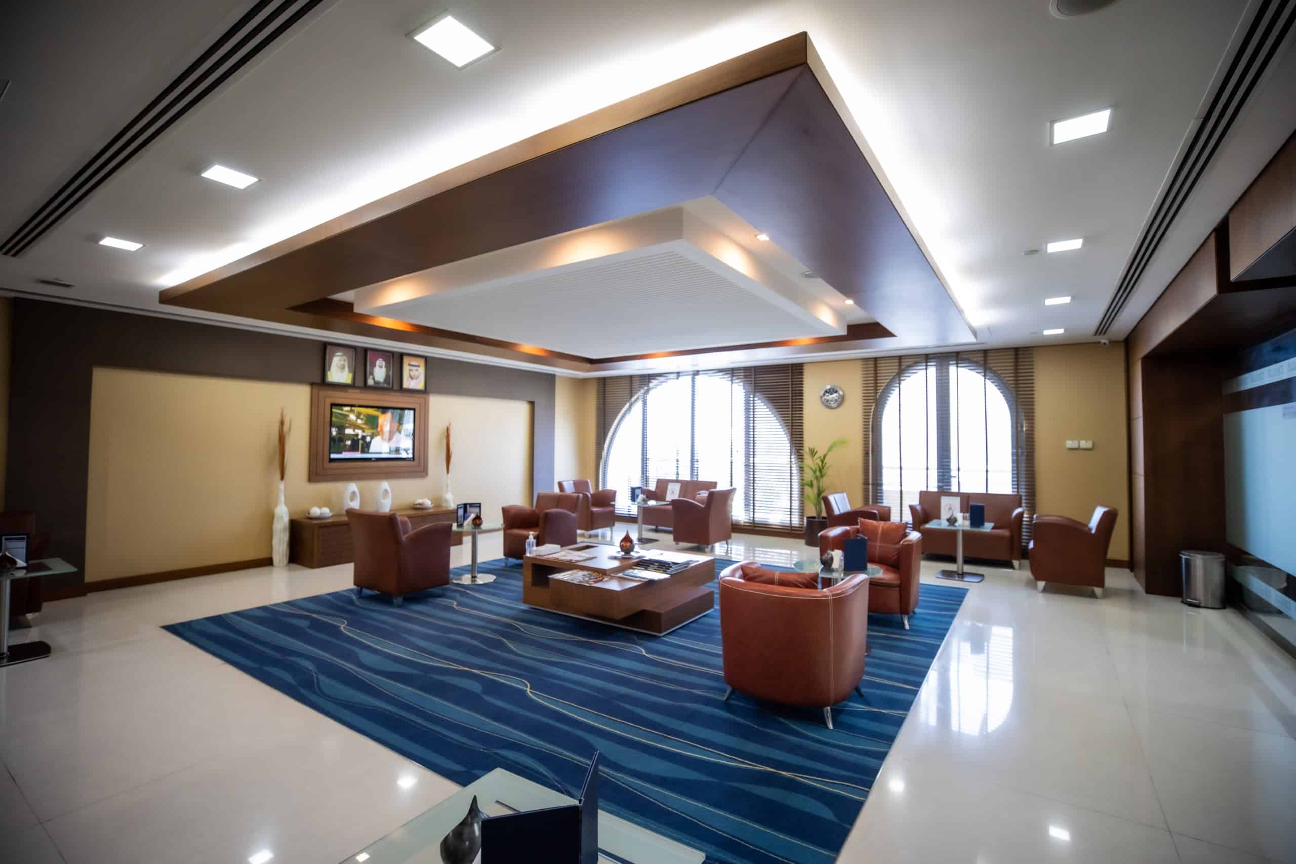 Spacious coworking area featuring leather chairs and large arched windows at Nextspace UAE.