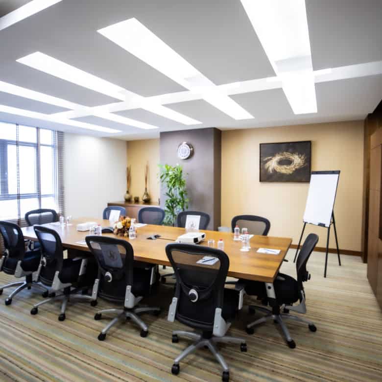 Bright, stylish office meeting room in Dubai UAE with conference table and chairs.