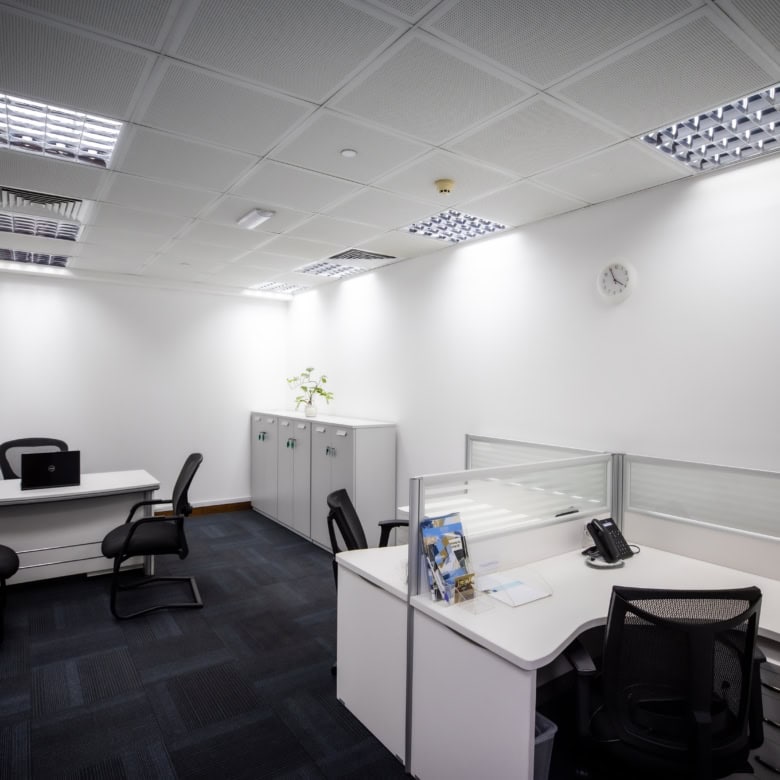 Bright office with contemporary furniture and work desks in Dubai coworking center.