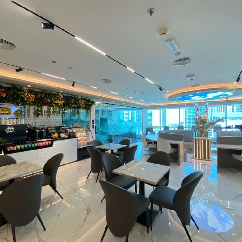 Bright, contemporary workspace at Nextspace UAE with stylish decor, seating areas, and scenic skyline views.