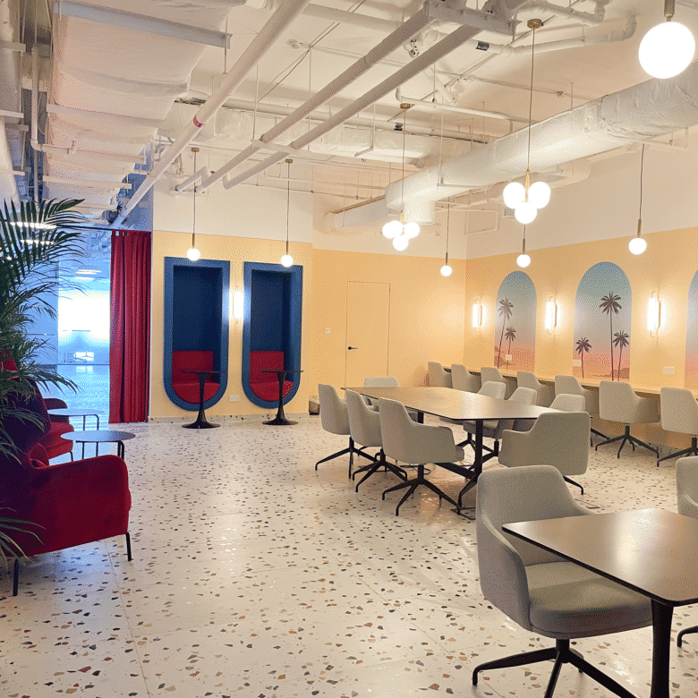 Bright coworking environment in Dubai featuring contemporary design, cozy seating, and vibrant decor.