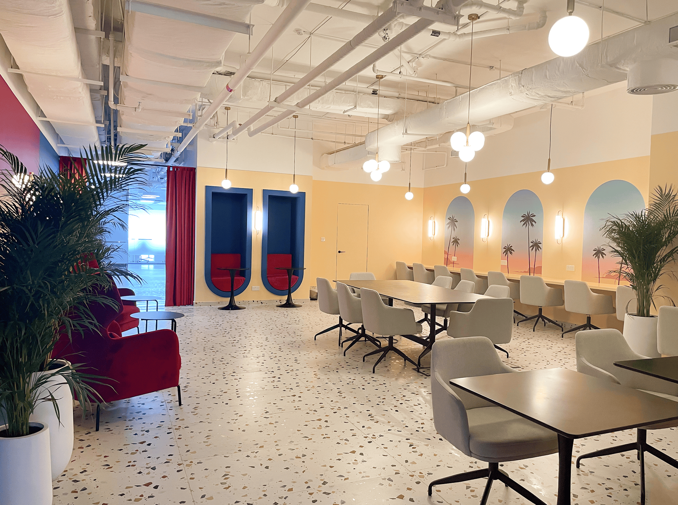 Bright coworking environment in Dubai featuring contemporary design, cozy seating, and vibrant decor.