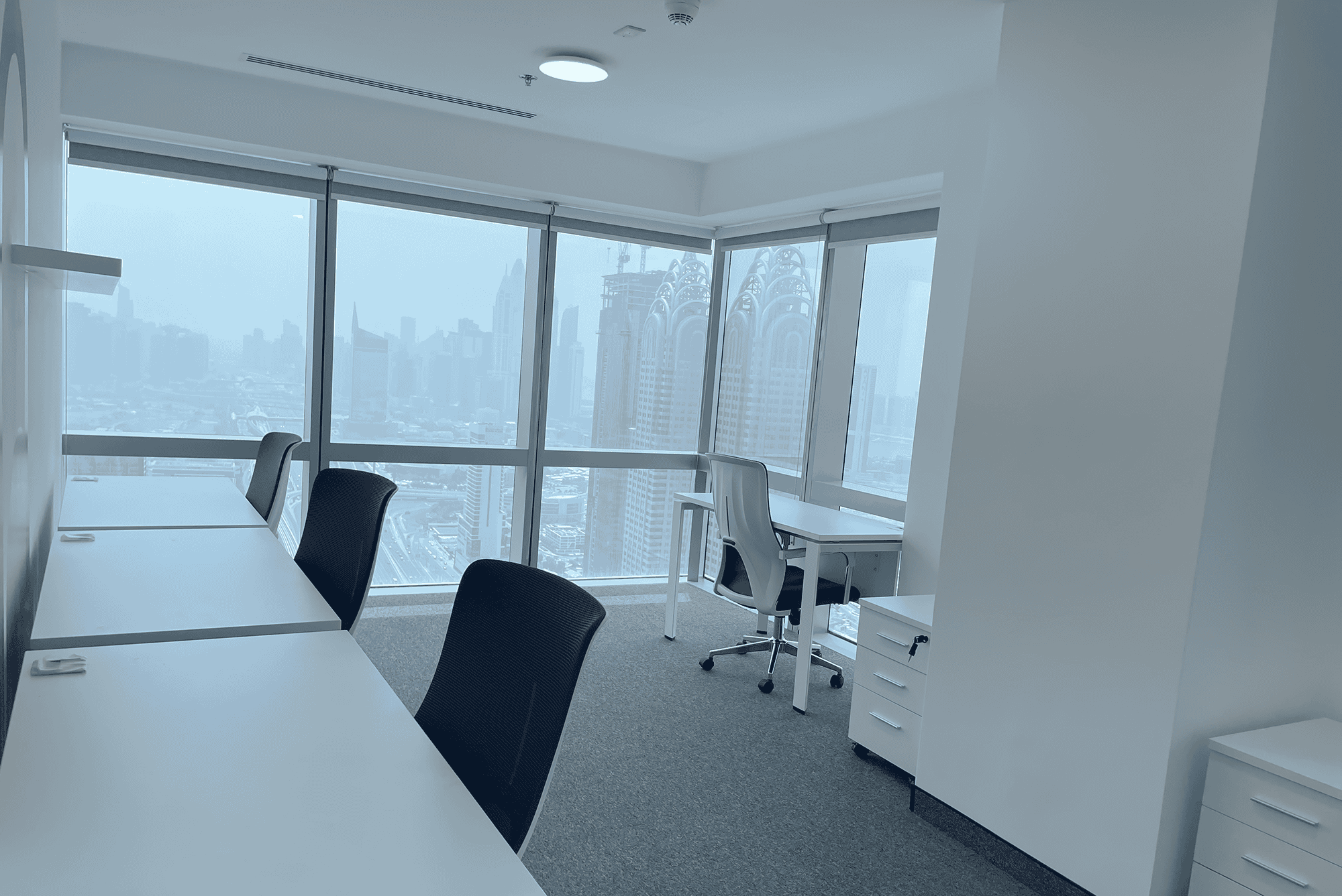 Bright office with large windows and ergonomic chairs in Dubai coworking space.