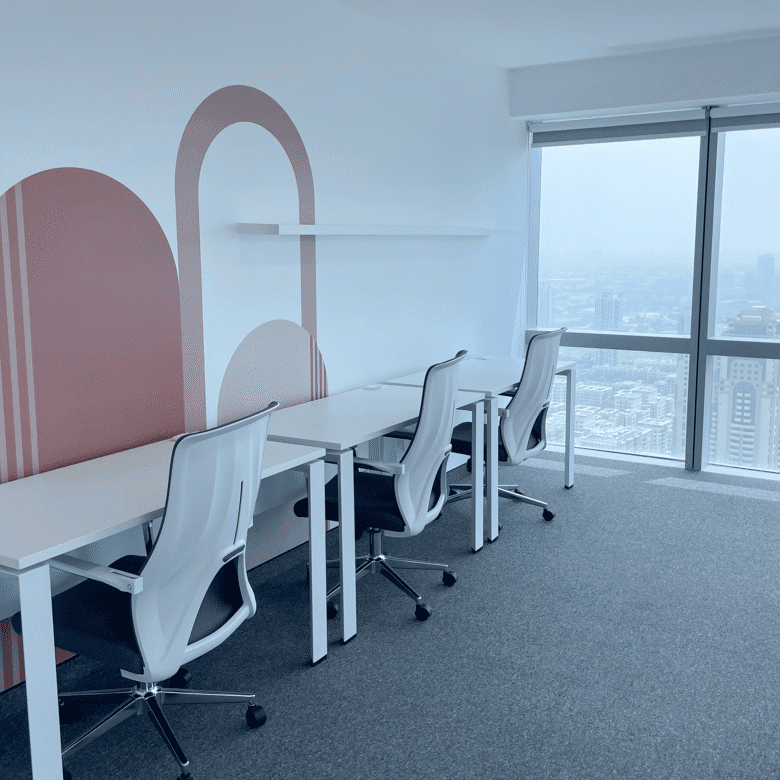 Bright, stylish office with comfortable chairs and large windows showing Dubai skyline.