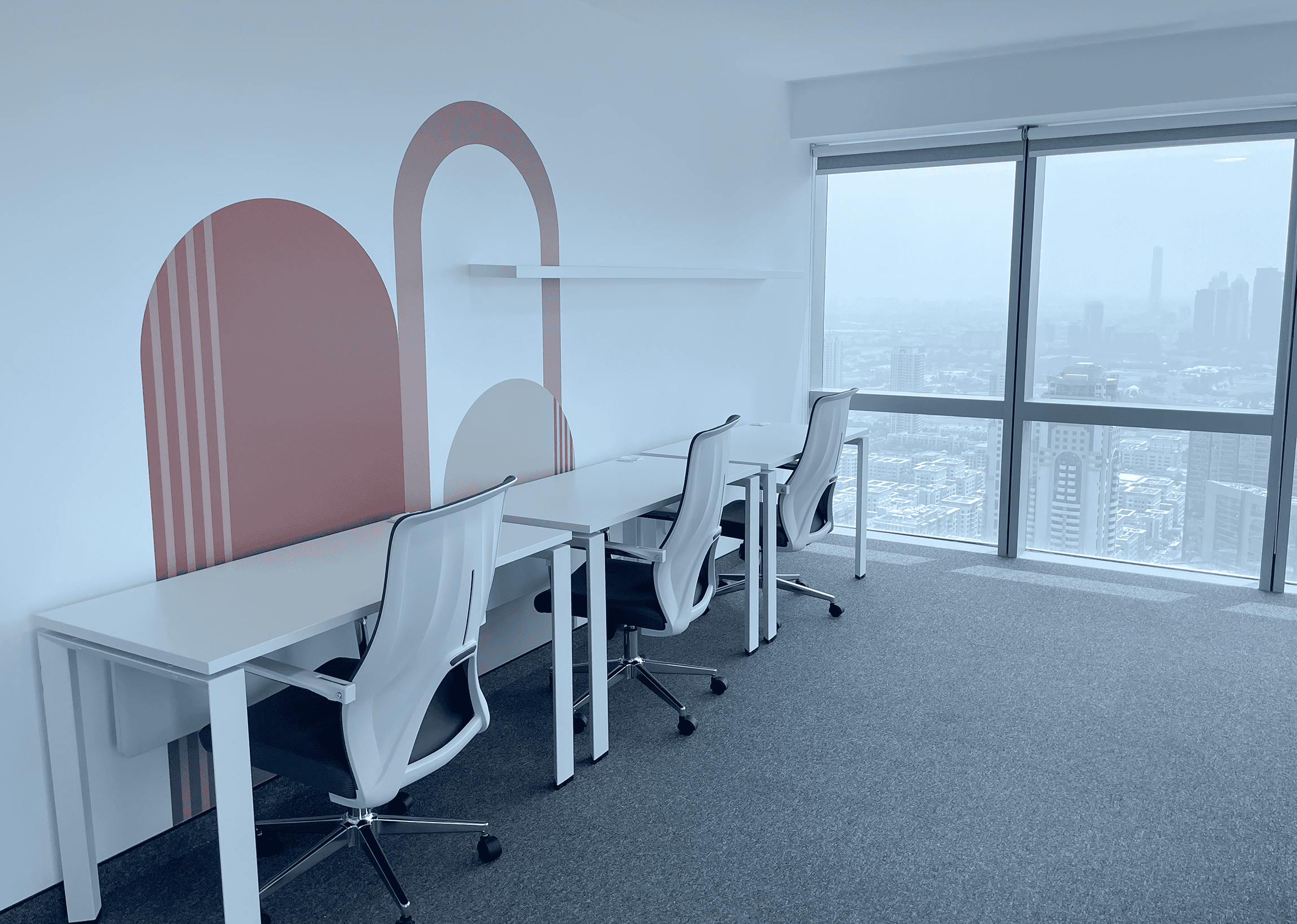Bright, stylish office with comfortable chairs and large windows showing Dubai skyline.