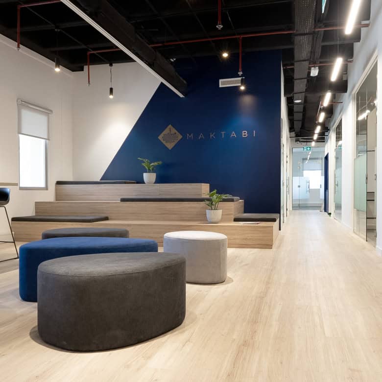 Bright co-working office in Dubai with contemporary furniture and natural lighting for productivity.