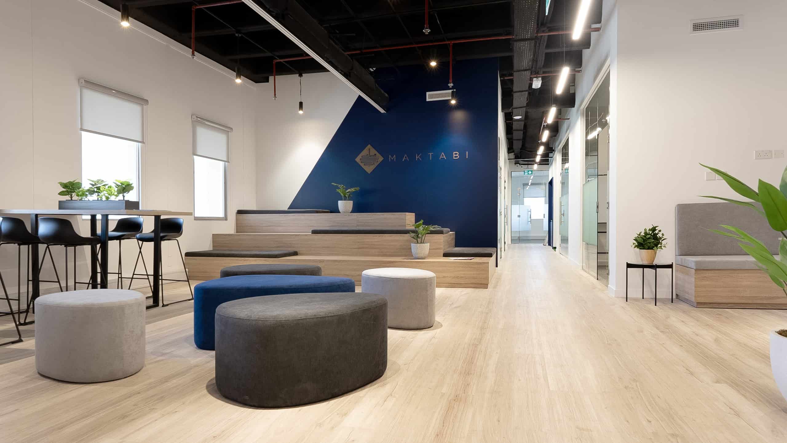 Bright co-working office in Dubai with contemporary furniture and natural lighting for productivity.