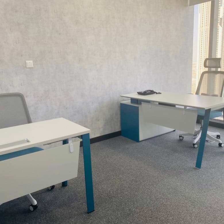 Contemporary coworking workspace near Dubai city skyline with large windows.