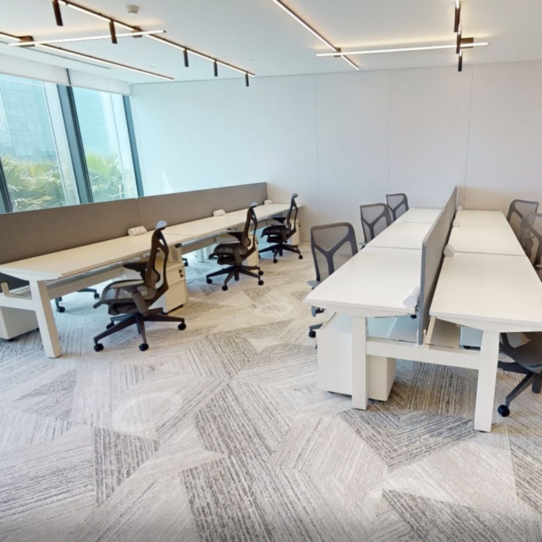 Bright, contemporary workspace with ergonomic chairs and large windows.