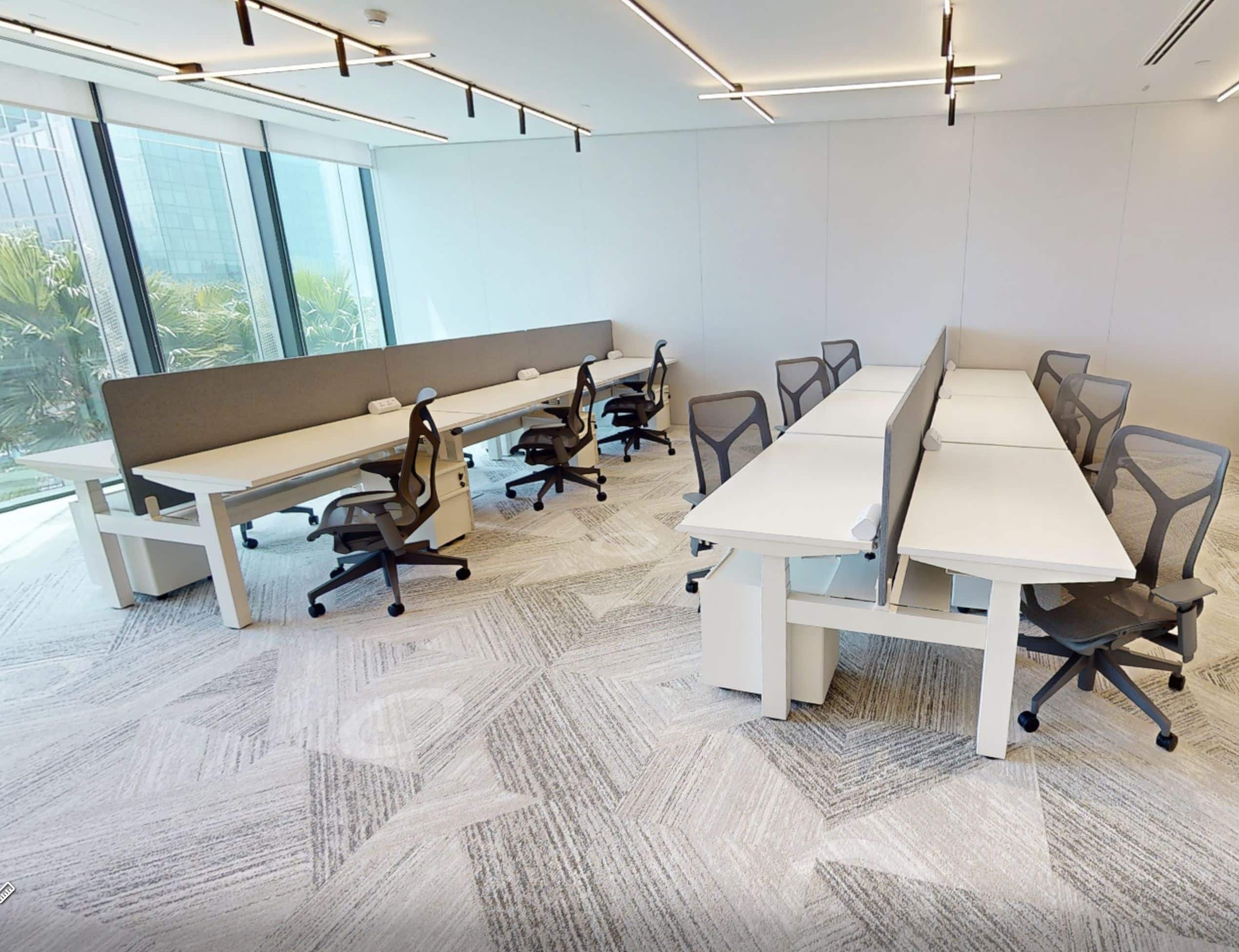 Bright, contemporary workspace with ergonomic chairs and large windows.