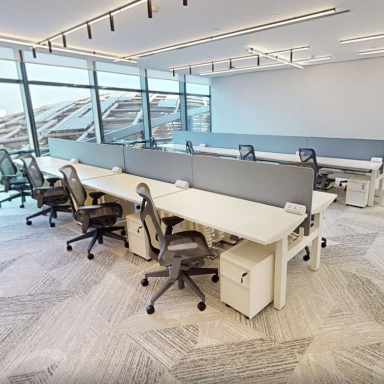 Bright, flexible office workspace with large windows at Nextspace UAE coworking center.