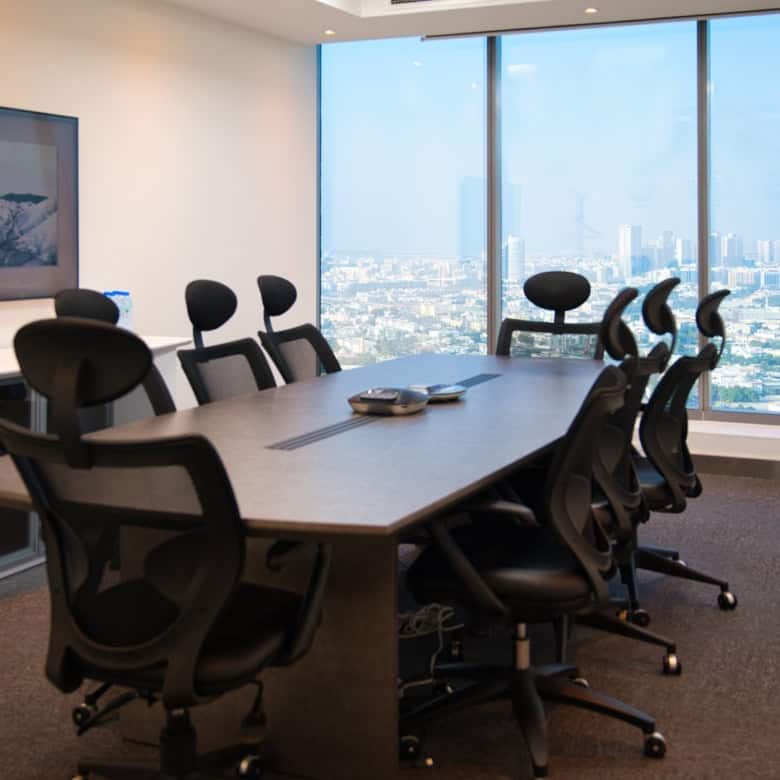 Spacious UAE coworking office with ergonomic chairs and large windows showcasing Dubai skyline.