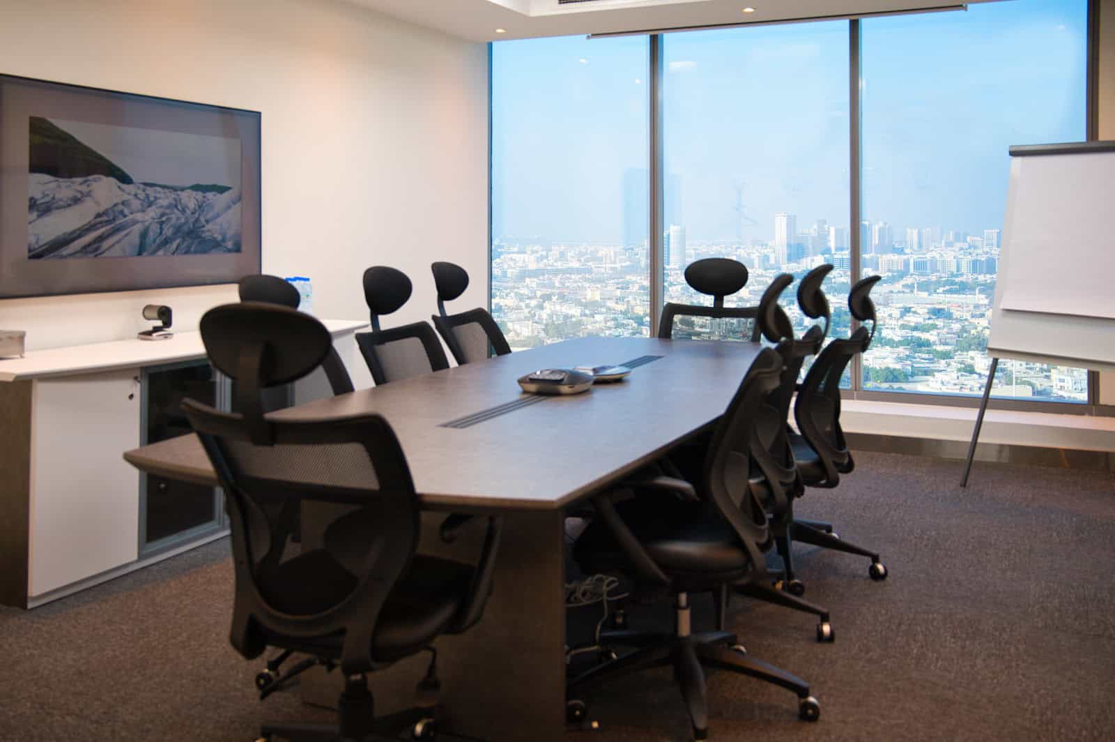 Spacious UAE coworking office with ergonomic chairs and large windows showcasing Dubai skyline.