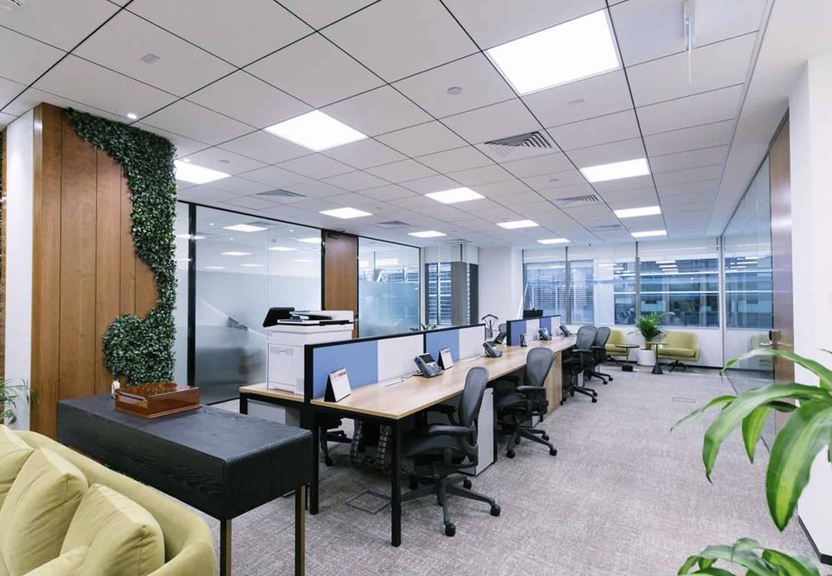 Spacious office with desks, chairs, and meeting areas.