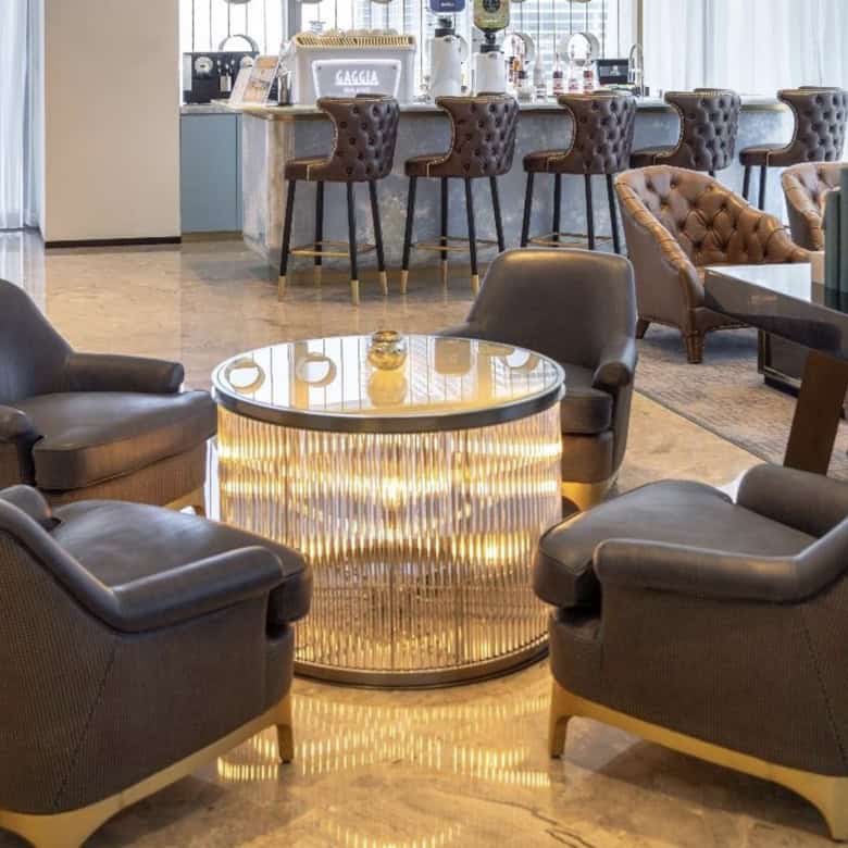 Spacious lounge area featuring contemporary chairs and elegant decor, ideal for remote work and networking.
