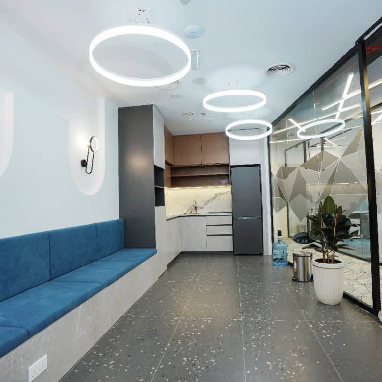 Bright corporate office interior featuring sleek design, modern lighting, and private meeting rooms in UAE.