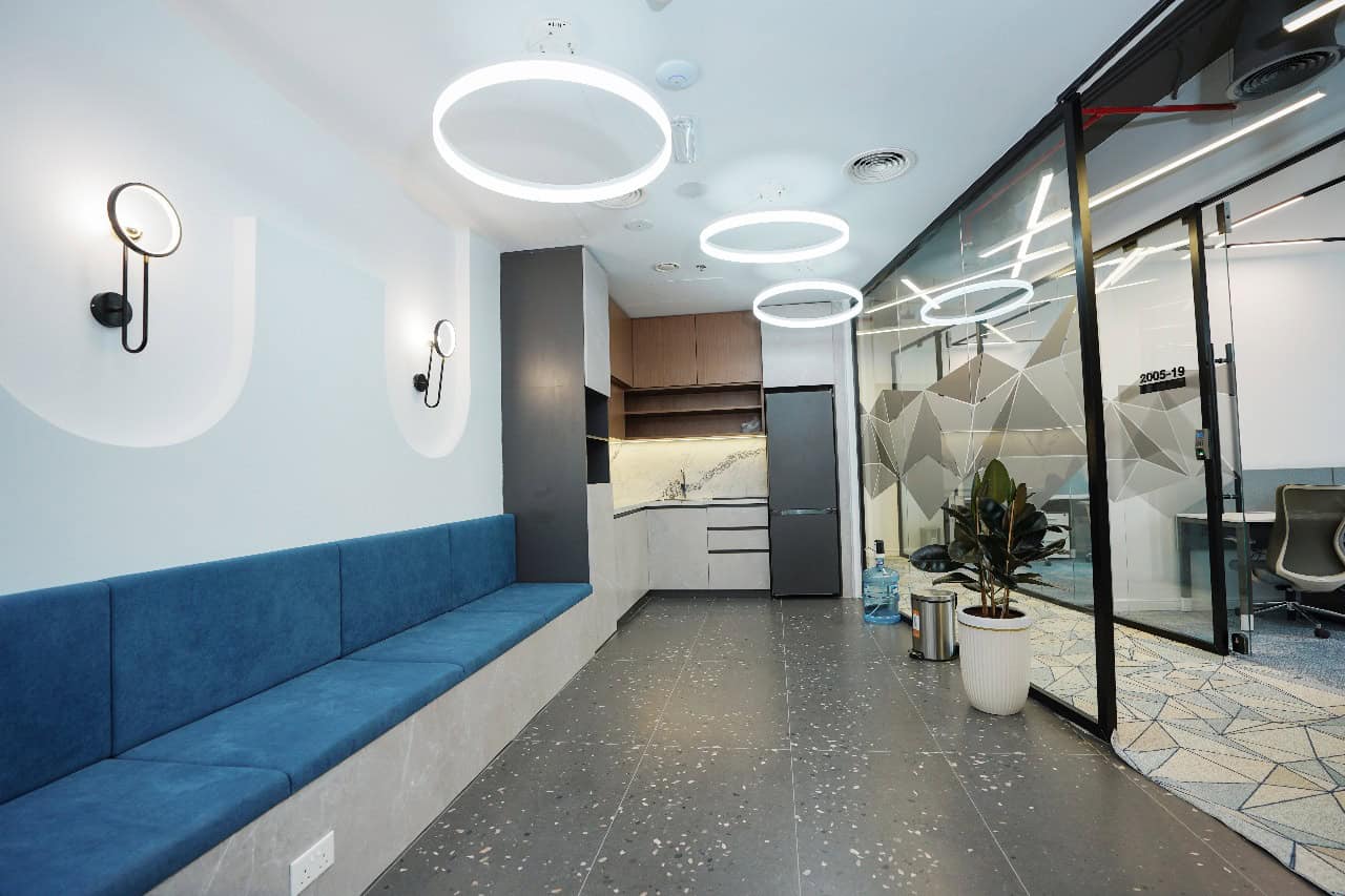 Bright corporate office interior featuring sleek design, modern lighting, and private meeting rooms in UAE.