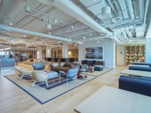 Spacious, stylish coworking environment with lounge areas, bookshelves, and modern design in Dubai UAE.