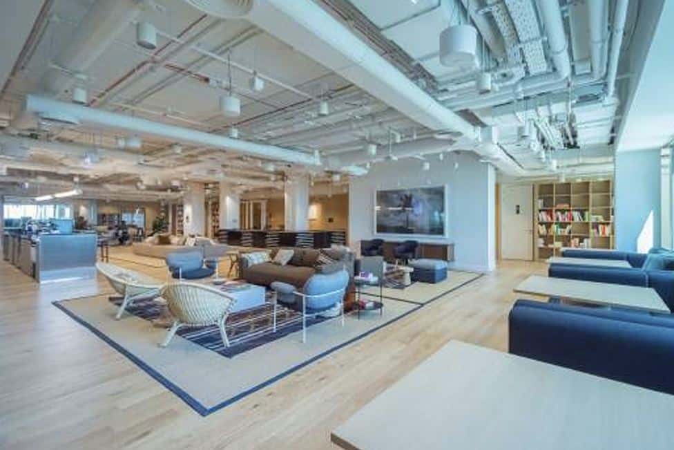 Spacious, stylish coworking environment with lounge areas, bookshelves, and modern design in Dubai UAE.