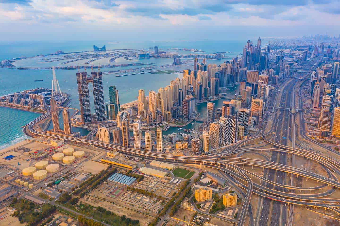 Aerial view of Dubai skyline showcasing vibrant business district, modern skyscrapers, and urban development for coworking spaces.