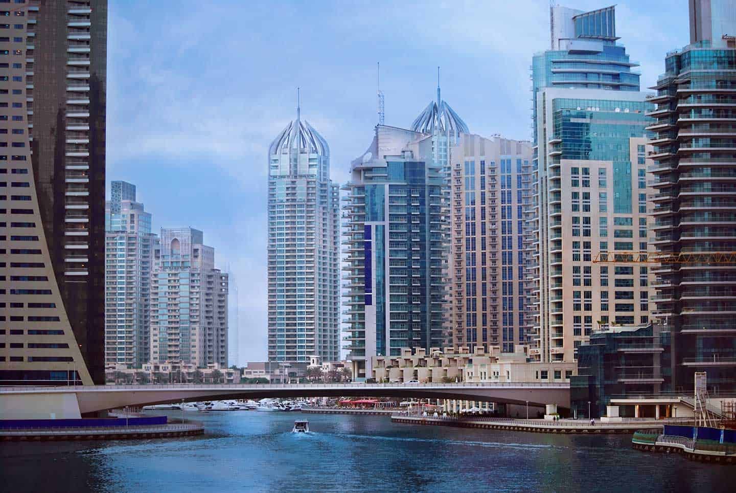 Cityscape of Dubai with tall skyscrapers and water, highlighting Nextspace UAE coworking office options.