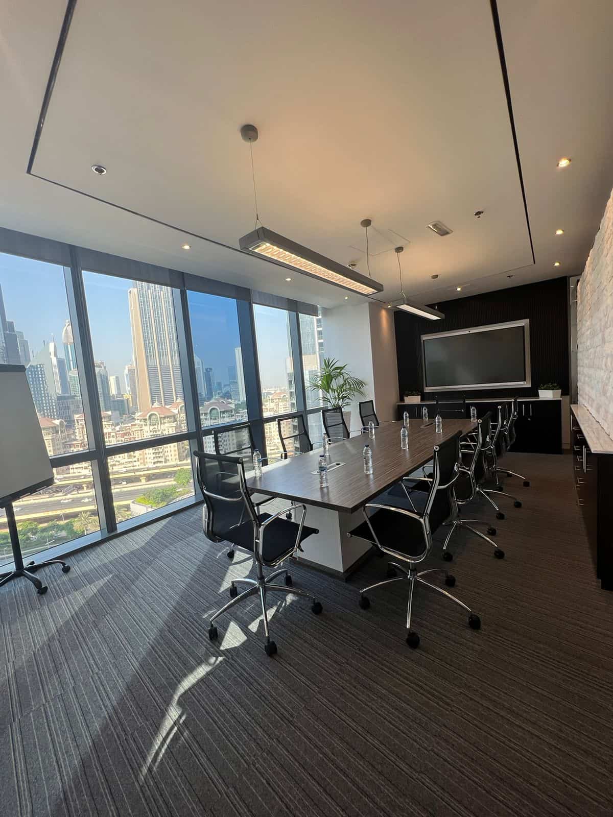 Spacious conference room featuring contemporary design, large windows, and cityscape in Dubai for professional meetings.