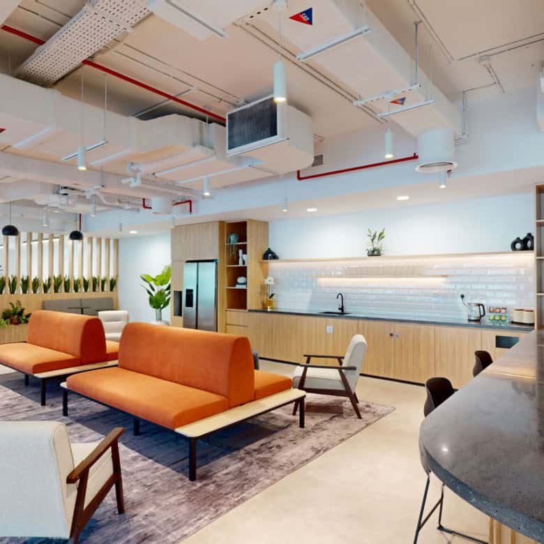Bright, contemporary coworking environment in UAE featuring cozy seating and a functional kitchen.