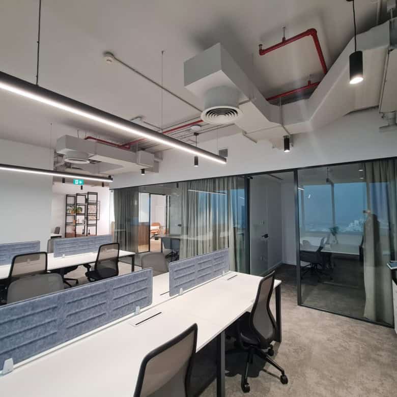 Spacious coworking office with private workstations, meeting rooms, and modern design in Dubai.