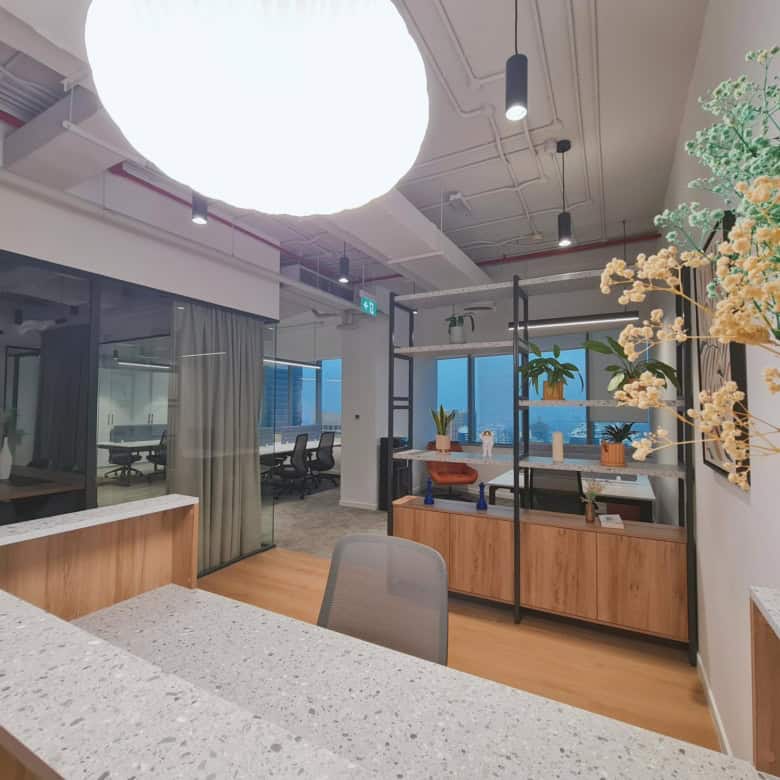 Bright office environment with plants, shelving, and large windows in UAE.