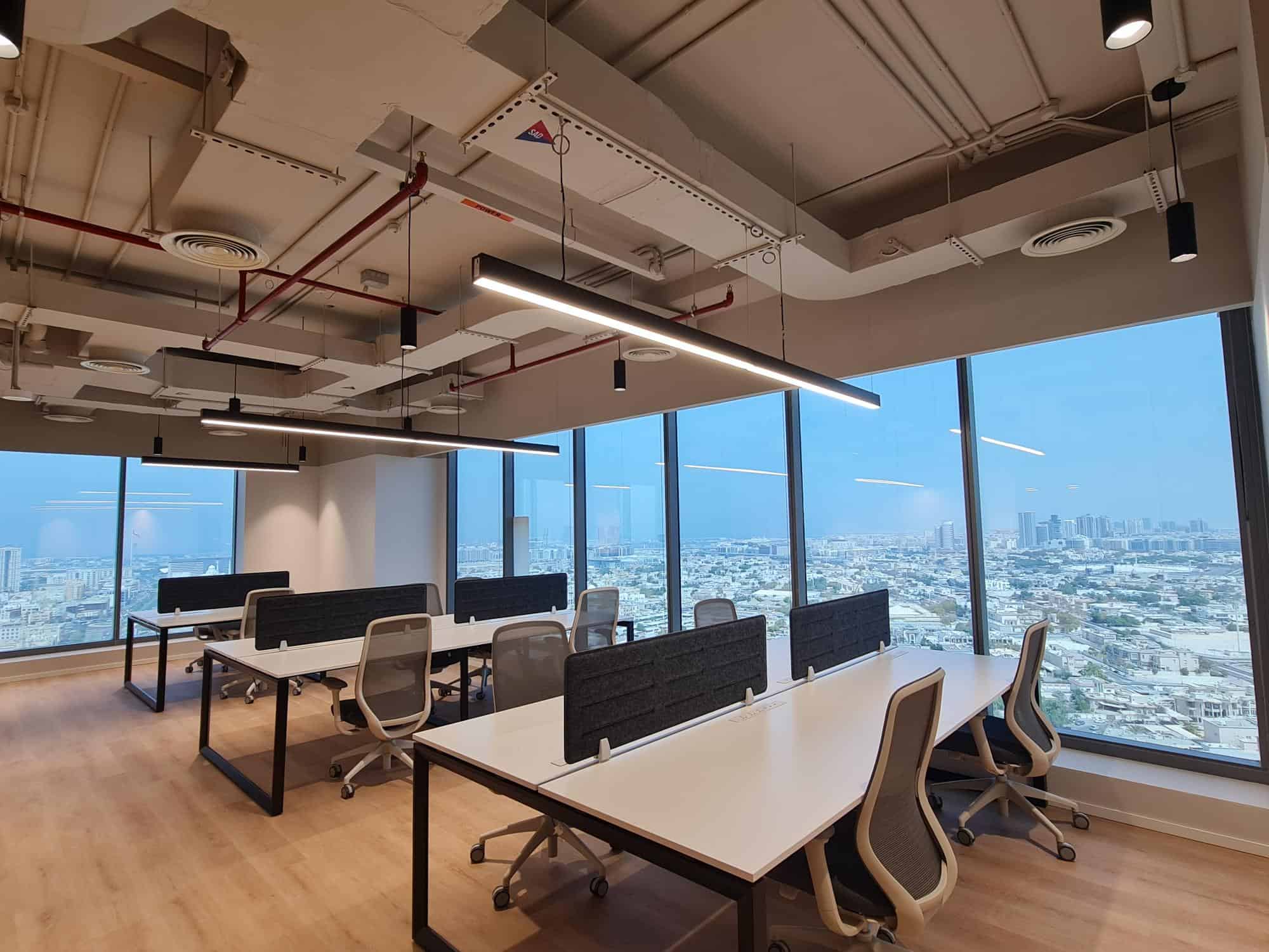 Bright office with panoramic city views, modern furniture, and flexible workspace for startups and professionals.