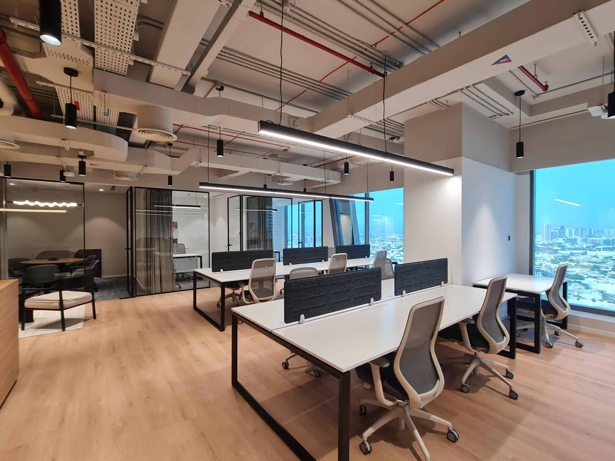 Bright, contemporary Dubai office featuring flexible workstations and scenic skyline views.