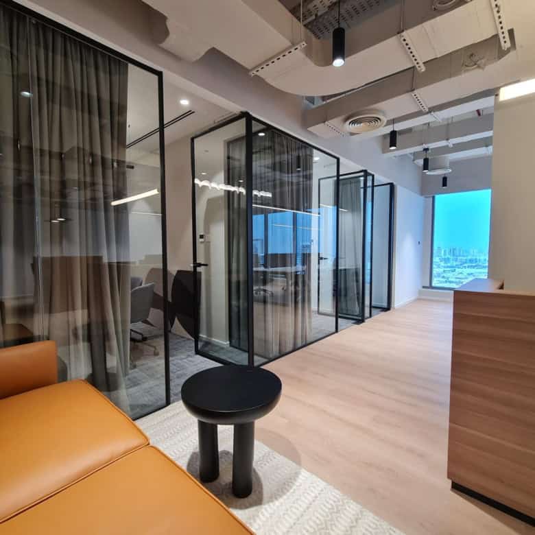 Innovative coworking office at Nextspace UAE featuring private glass meeting rooms and a bright, professional environment.