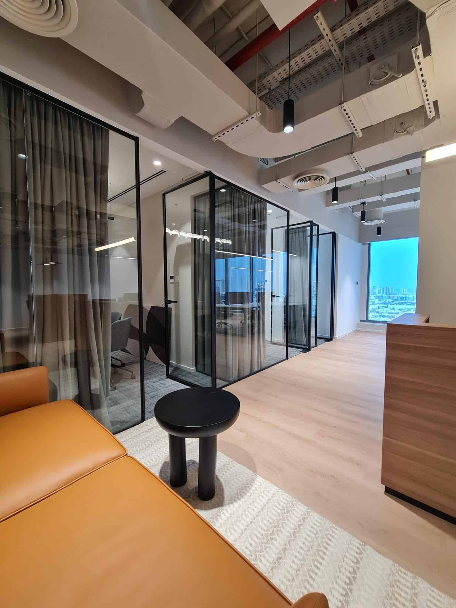 Innovative coworking office at Nextspace UAE featuring private glass meeting rooms and a bright, professional environment.