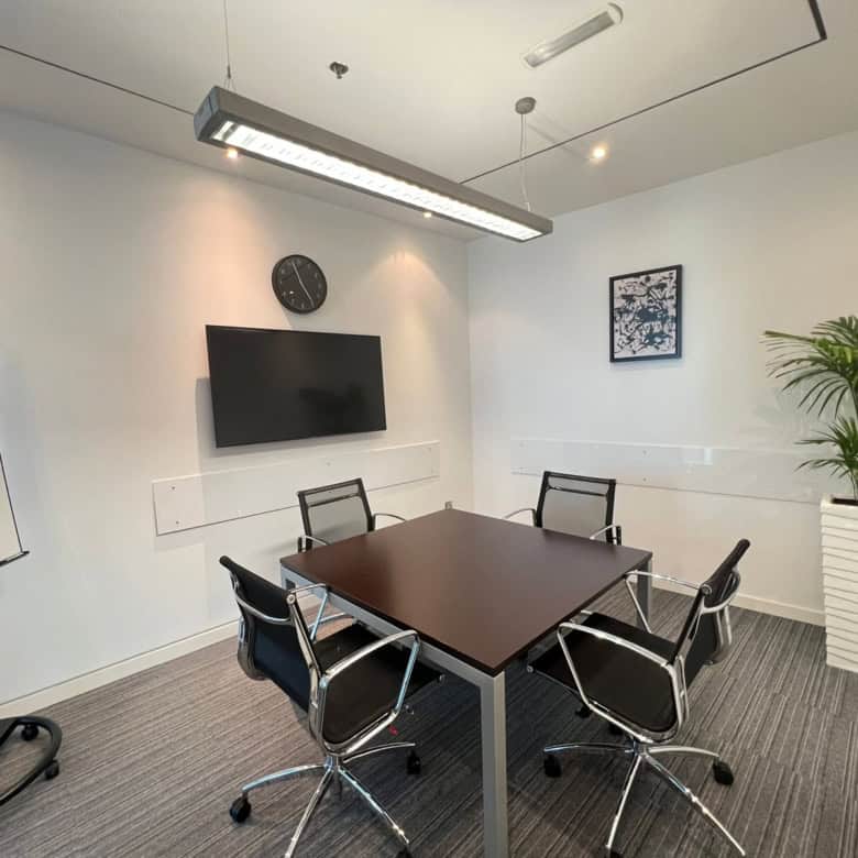 Modern coworking space in Dubai with meeting rooms and workstations.