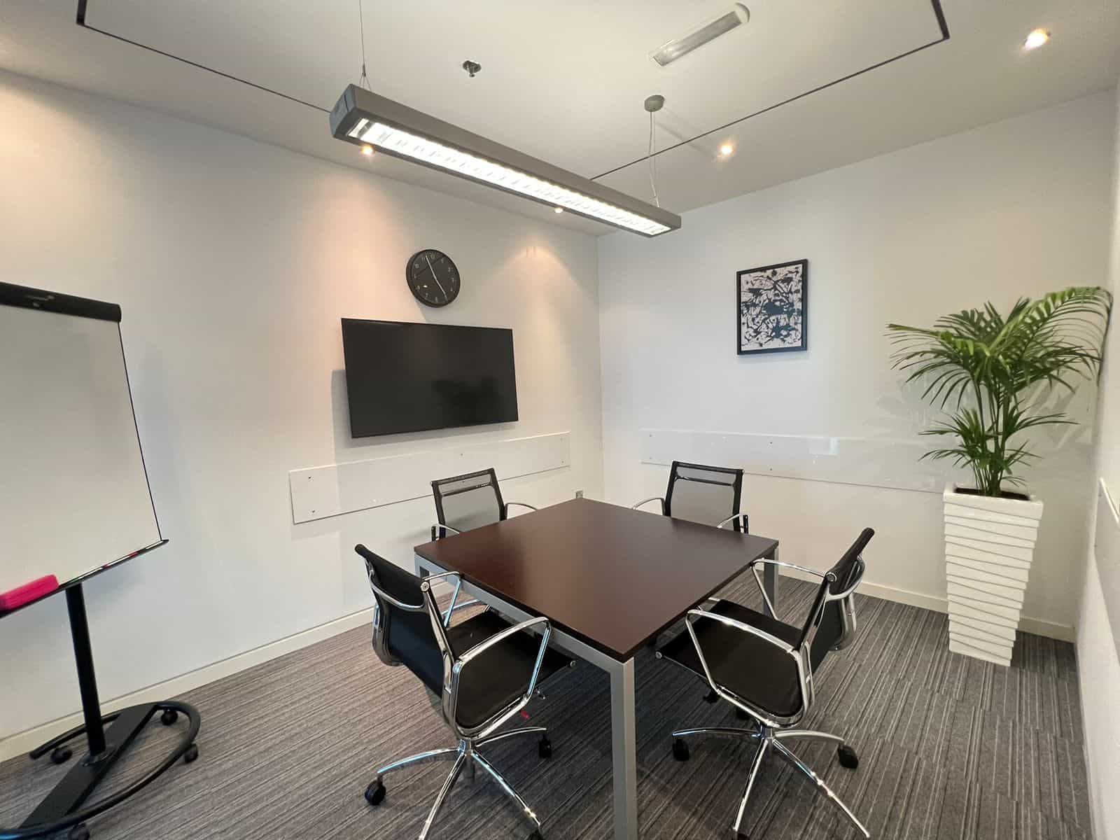 Modern coworking space in Dubai with meeting rooms and workstations.