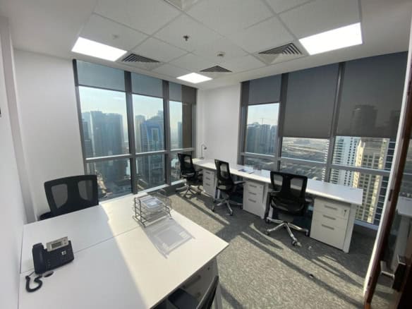 Bright office with large windows and cityscape view in Dubai, ideal for startups and remote teams.