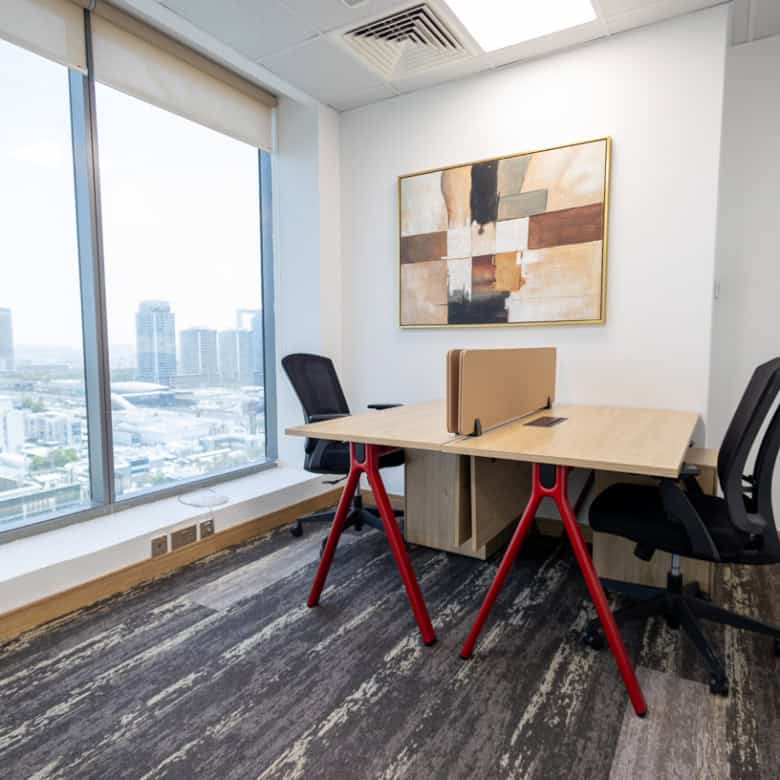 Office interior at Nextspace UAE with large windows and modern furniture.