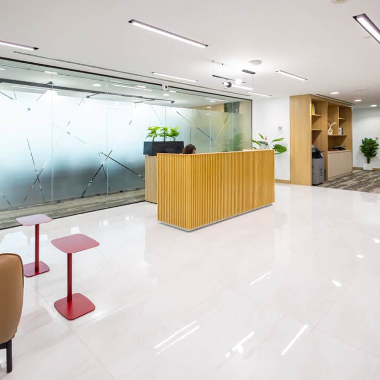 Bright, stylish reception area at Nextspace UAE coworking hub with comfortable seating and plants.