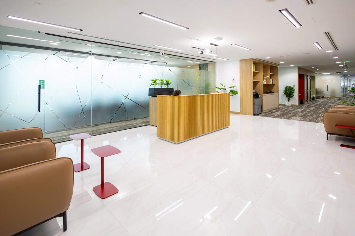 Bright, stylish reception area at Nextspace UAE coworking hub with comfortable seating and plants.