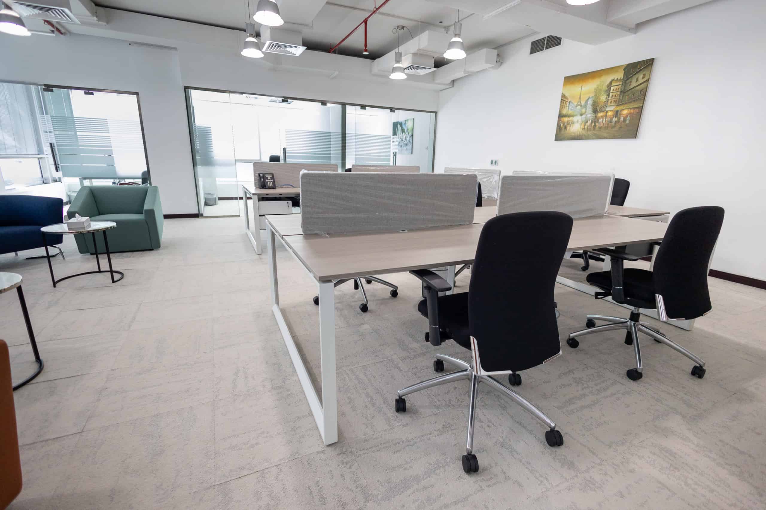 Comfortable desks and office chairs in a stylish coworking environment in Dubai.