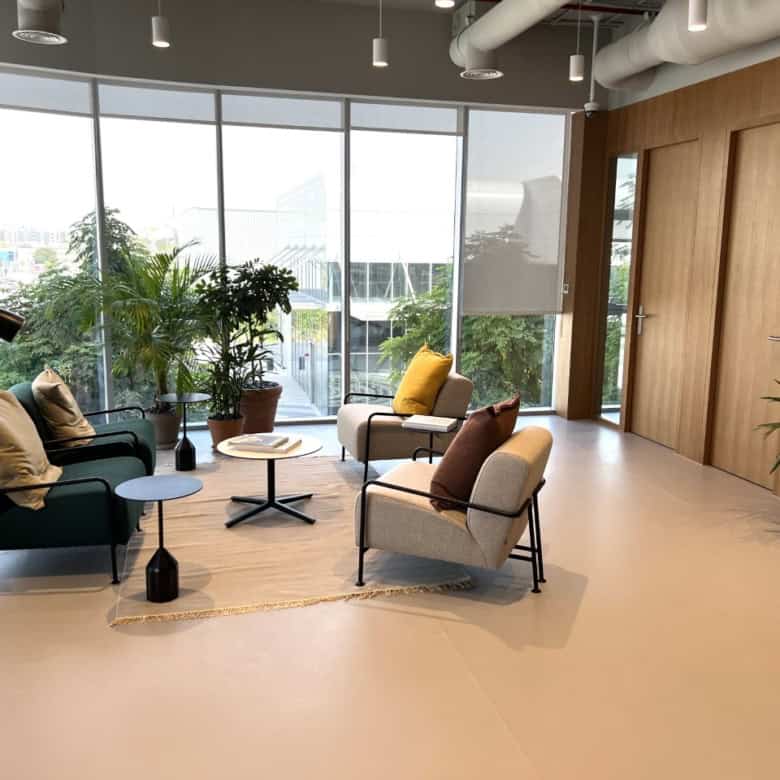 Comfortable lounge area with plants and natural light, ideal for remote work or meetings in Dubai.