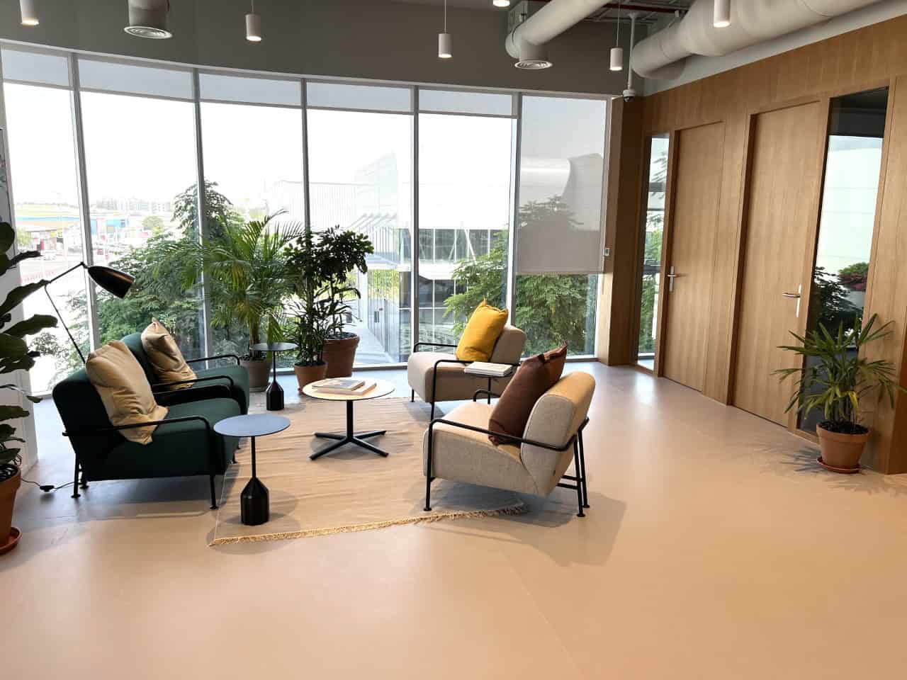 Comfortable lounge area with plants and natural light, ideal for remote work or meetings in Dubai.