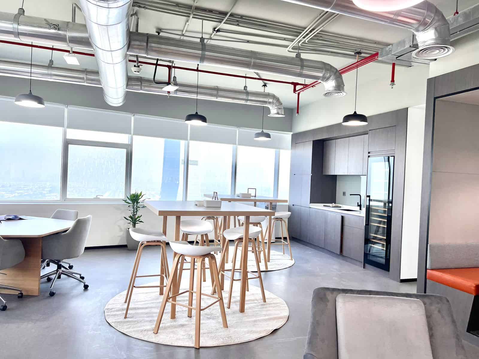 Bright, contemporary office space with high ceilings, large windows, and modern furnishings in Dubai UAE.