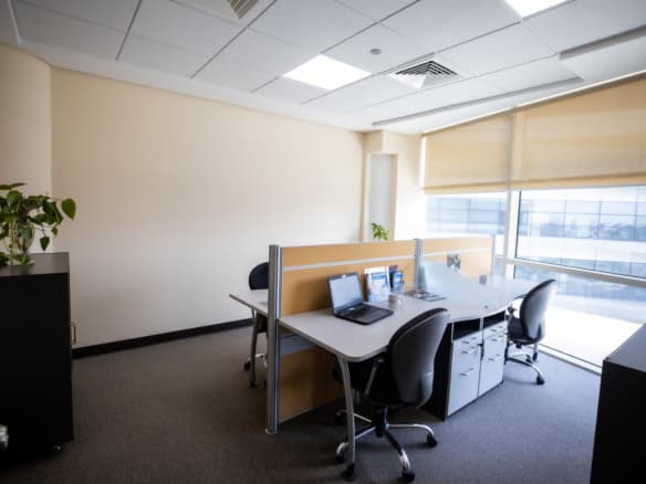 Bright office with large windows, ergonomic chairs, and startup-friendly environment in Dubai.