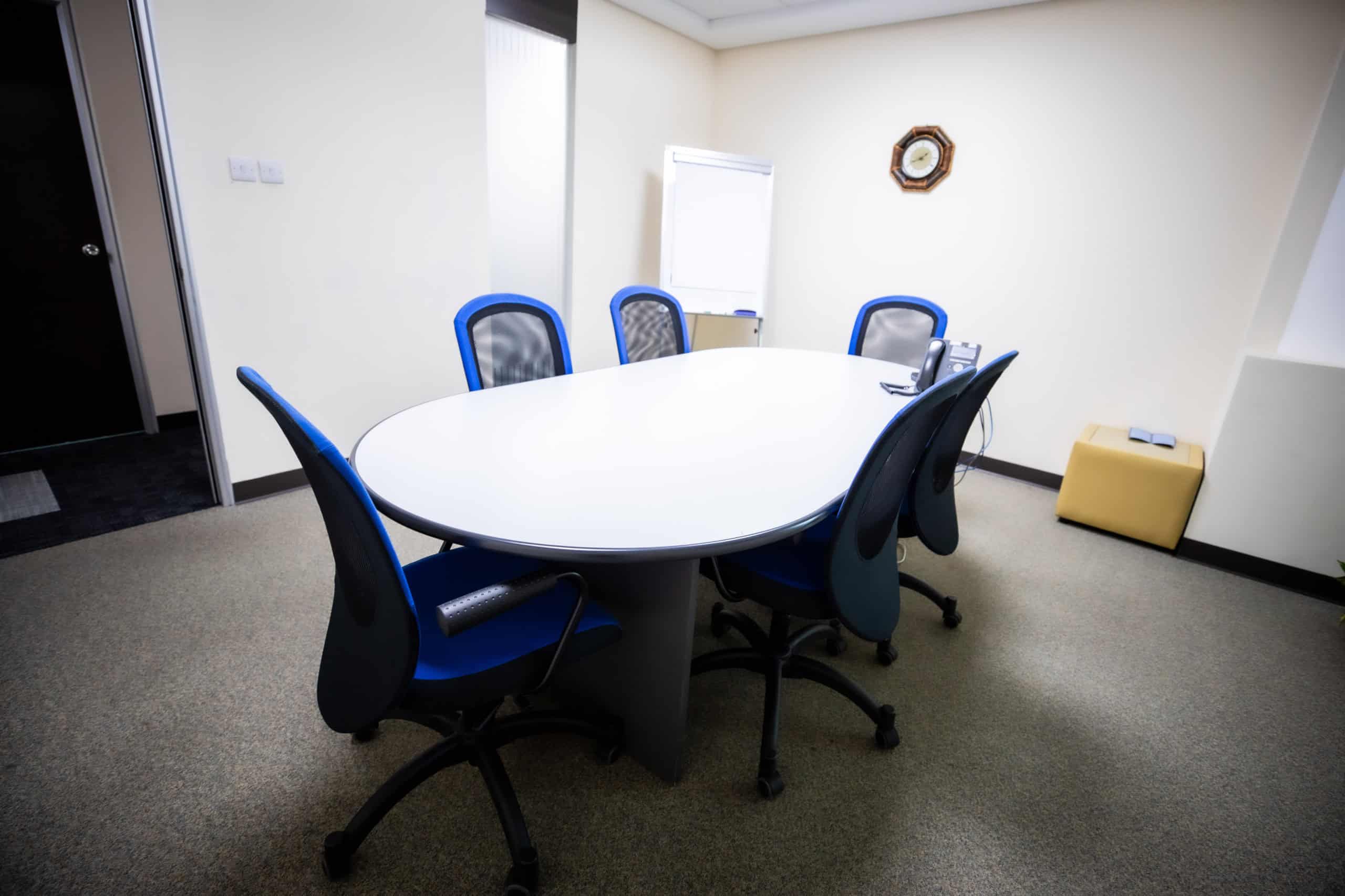 Bright modern conference room with office chairs, table, and equipment in Dubai.