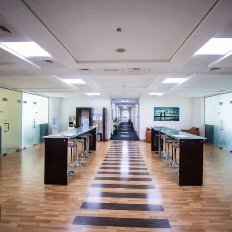 Bright shared workspace with contemporary furniture and natural lighting in UAE office.