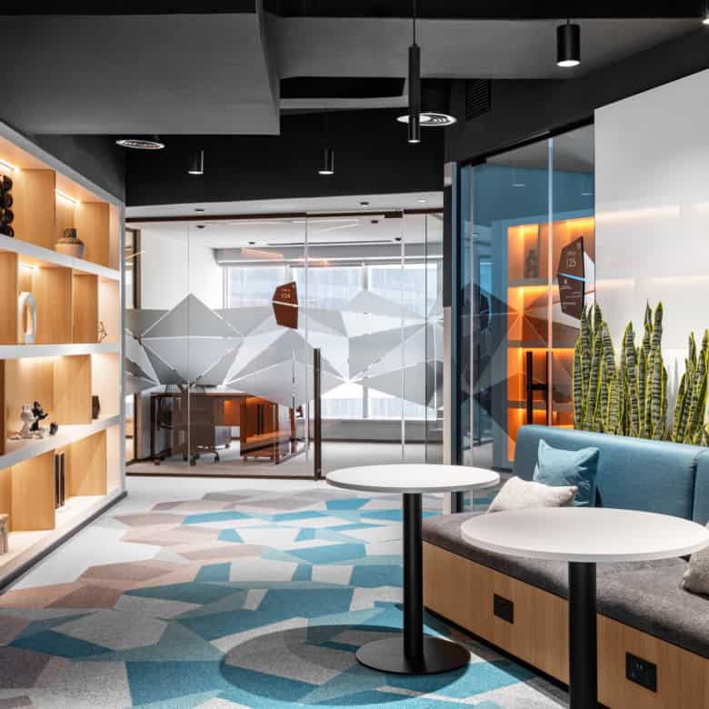 Bright, inviting office lounge with contemporary design, sofas, and natural lighting.