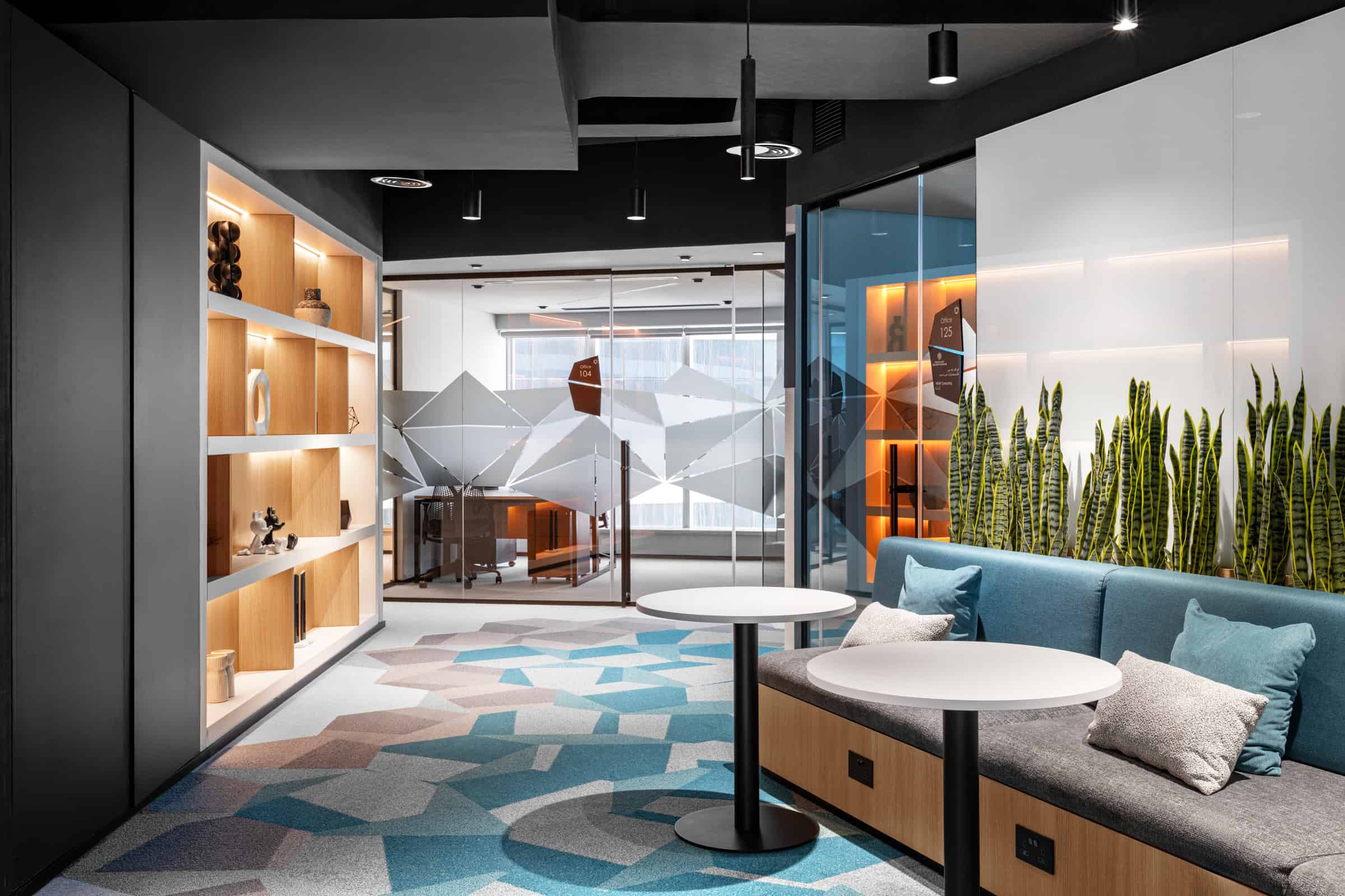 Bright, inviting office lounge with contemporary design, sofas, and natural lighting.